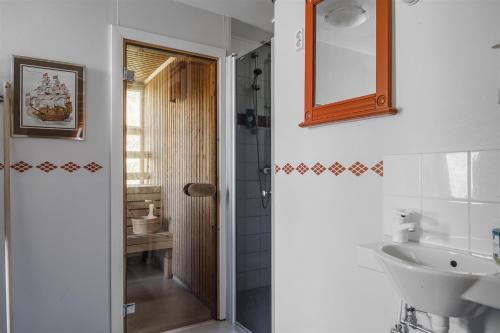 a bathroom with a sink and a toilet and a mirror at Skogsbrynet B&B, Bredsjö Nya Herrgård in Hällefors