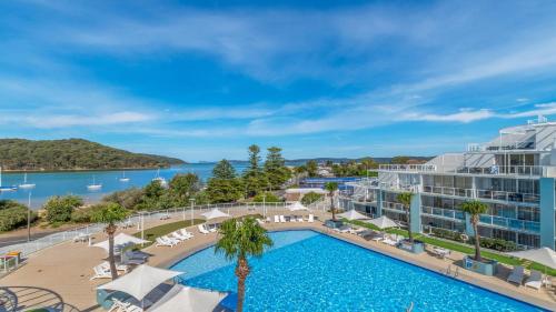 an image of the pool at the resort with a view of the water at Blue Ocean in Ettalong Beach