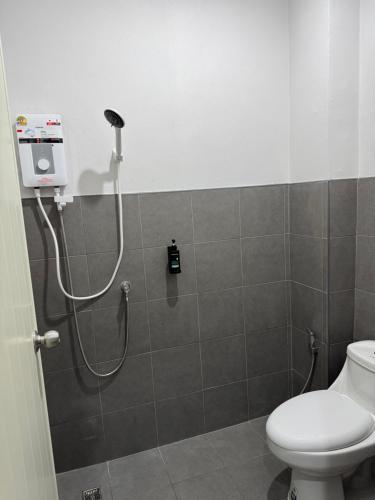 a shower in a bathroom with a toilet at GlassHouse in Udon Thani