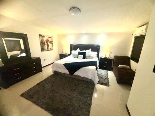 a bedroom with a bed and a mirror and a chair at Casa Futuro in San Lorenzo