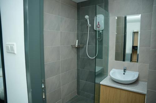 a bathroom with a shower and a sink at Arena Suites Kuala Lumpur in Kuala Lumpur
