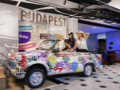 a group of people standing next to a car at Mercure Budapest Castle Hill in Budapest
