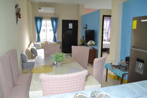 a kitchen and living room with a table and chairs at Casa Albacora in Puerto Baquerizo Moreno