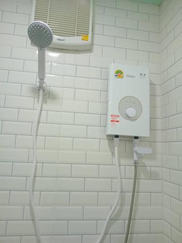 a shower in a bathroom with a blow dryer at KOOK BUNGALOW in Ko Mook