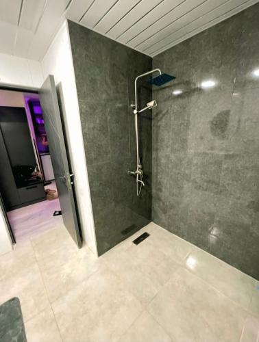 a bathroom with a shower with a glass door at Apartment tsaghkadzor SHINE HOME in Tsaghkadzor
