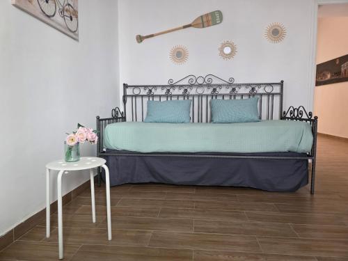 a bedroom with a bed and a table with flowers at La Casa di Maty in Reggio Calabria