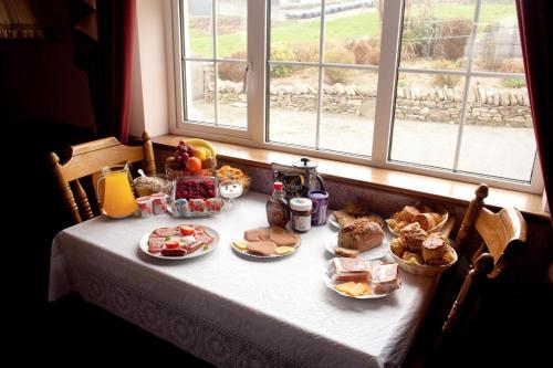 a table with food on it with a window at Atlantic View B&B in Liscannor
