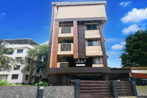 a tall apartment building with a sign on it at Super Collection O New Jalpaiguri Railway Station Formerly Prince Lodge in Siliguri