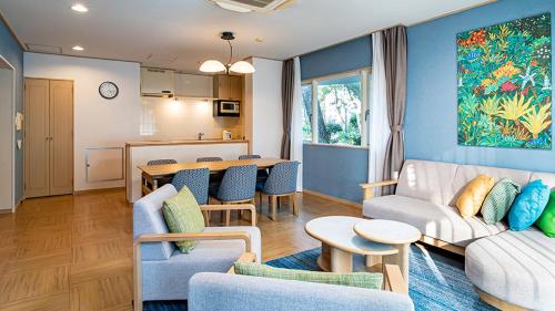 a living room with a couch and a table at Seagaia Forest Cottages in Miyazaki