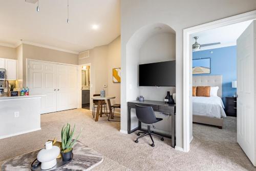 a bedroom with a bed and a desk at Landing Amazing 1BD Gym in Webster