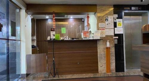 a lobby with a large wooden counter in a building at Darlene Hotel in Singapore