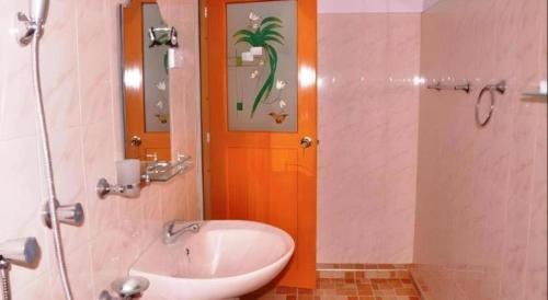 a bathroom with a sink and a shower at Hotel Tangoreef in Tangalle