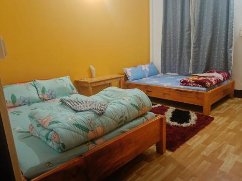 a room with two beds and a couch at Eton Homestay in Dirang Dzong