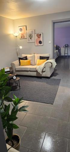 a living room with a couch in a living room at B&B Evasion Appartment in Mons
