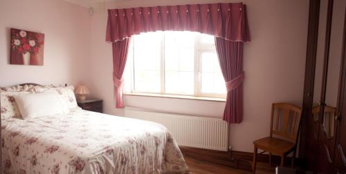 a bedroom with a bed and a window at Atlantic View B&B in Liscannor