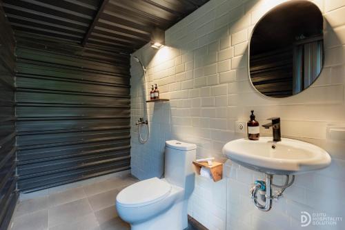 a bathroom with a toilet and a sink at Green Lava Lake View Glamping Bedugul By IHM in Bedugul