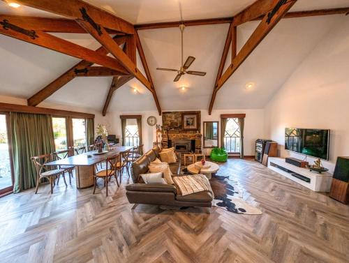 a living room with a couch and a table at Lakeside haven cottage - Macedon ranges in Riddell
