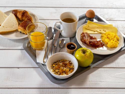- un plateau de petit-déjeuner composé d'œufs, de bacon et de pain grillé dans l'établissement ibis Paris Pantin Eglise, à Pantin