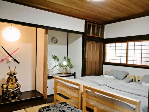 a bedroom with a large bed in a room at HS Japan STAY 瀬戸内 in Takamatsu