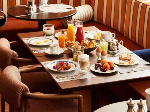 a breakfast table with breakfast foods and drinks on it at Sofitel Paris Baltimore Tour Eiffel in Paris