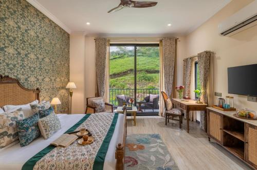a hotel room with a bed and a desk and a television at Villasita Udaipur in Udaipur
