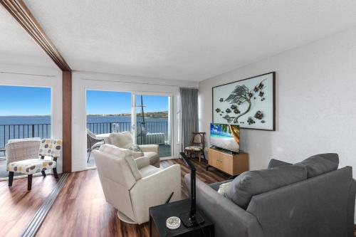 a living room with a couch and chairs and a television at Alii Villas #230 condo in Kailua-Kona