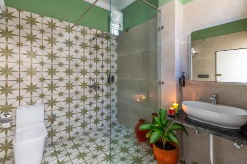 a bathroom with a sink and a toilet and a mirror at Villasita Udaipur in Udaipur