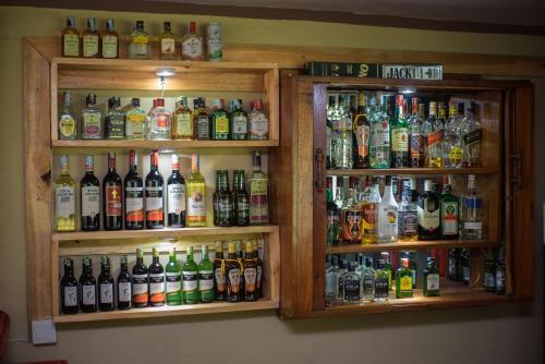 a bunch of different types of alcohol bottles at Arusha Giraffe Lodge in Arusha