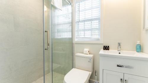 a bathroom with a shower and a toilet and a sink at Paradise Point by AvantStay Golf Course Living in Stock Island