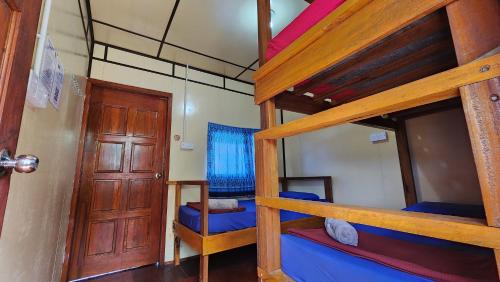 a room with two bunk beds and a door at Kiau View Cabin in Kota Belud