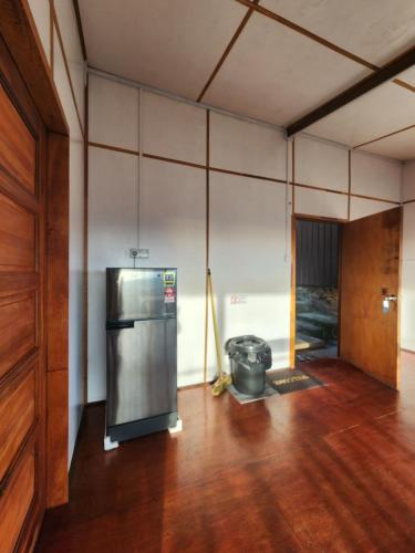 a kitchen with a stainless steel refrigerator in a room at Kiau View Cabin in Kota Belud