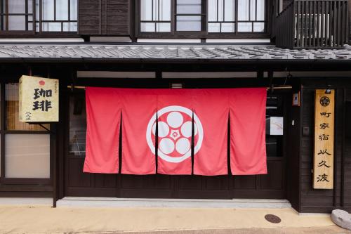 a red banner on the front of a building at 筑後吉井 町家宿 以久波 in Ukiha