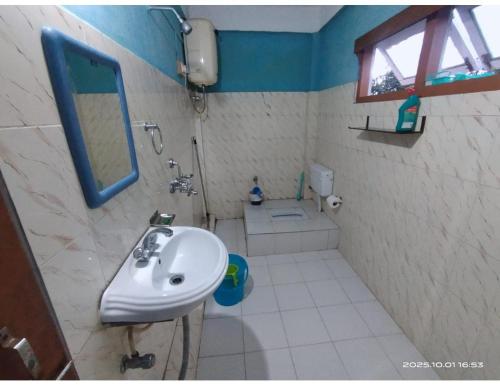 a bathroom with a sink and a mirror at Ngima woizer Homestay,Tawang in Tawang