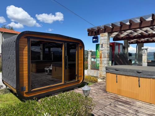 a tiny house sitting on top of a deck at Family Hotel Eterno in Tsigov Chark