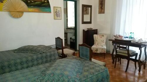 a living room with a bed and a table and a dining room at B&B Carla in Pisa