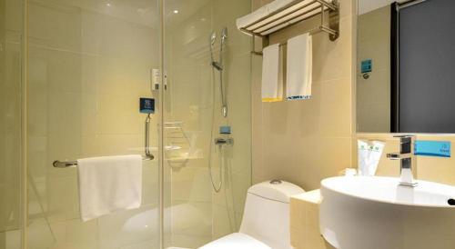 a bathroom with a shower and a toilet and a sink at City Comfort Inn Wuhan Hanyang Street Caidian Square Metro Station in Wuhan
