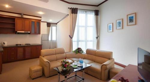 a living room with a couch and a table at CWD Hotel in Hanoi