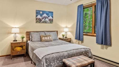 a bedroom with a bed and a window at Deer Hollow by AvantStay Big Yard Lake Access in Albrightsville