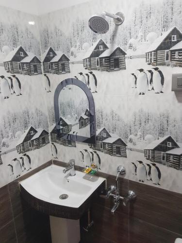 a bathroom with a sink and a snow covered wall at Mannata Homesaty in Darjeeling