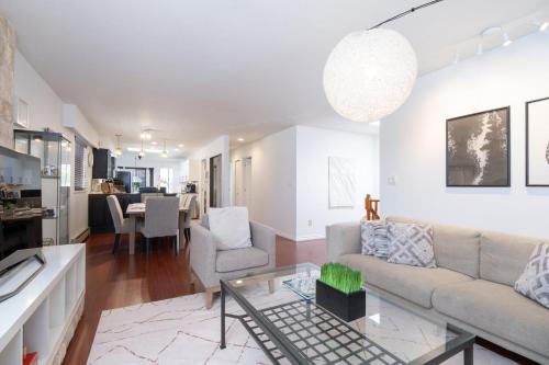 a living room with a couch and a table at 3BR Near Commercial Dr 10 min to Downtown in Vancouver