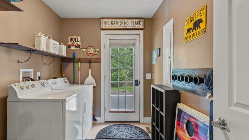 a laundry room with a washer and dryer at Chalet on Chalet by AvantStay Bright Cabin w Deck Fire Pit Near Lake in Lake Harmony