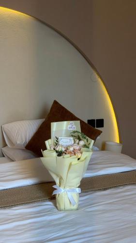 a bouquet of flowers in a vase on a bed at Essa camp in Wahiba Sands in Al Raka