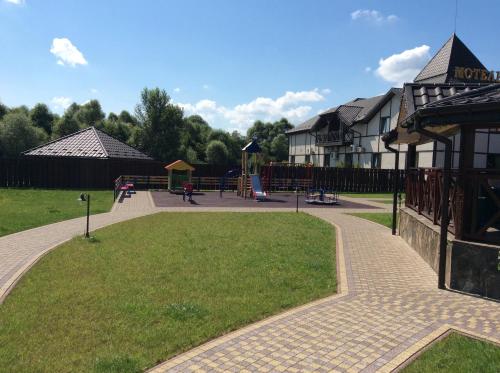a park with a playground and a building at Hotel Vulyk in Duliby