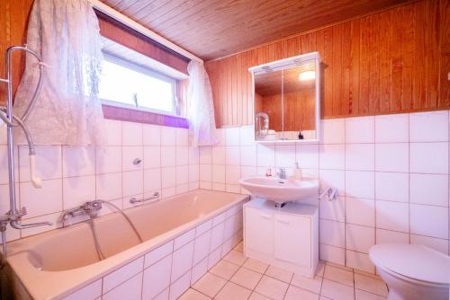 a bathroom with a tub and a sink and a toilet at Comfortable Apartment in Lauenburg Elbe in Lauenburg
