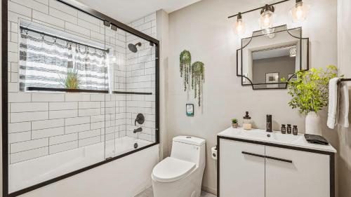 a bathroom with a toilet and a sink and a mirror at Emerald Bluff by AvantStay Lake Views Deck Fire Pit Game Room in Long Pond