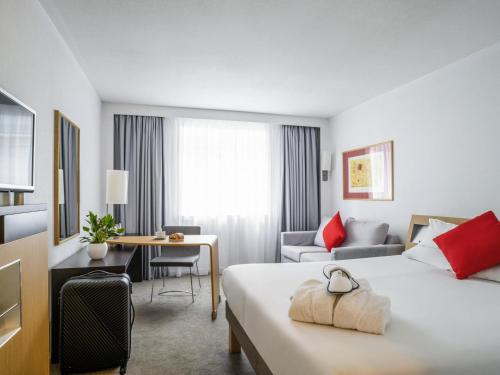 a hotel room with a bed and a desk at Novotel Glasgow Centre in Glasgow