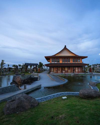 a building with a pond in front of a building at Hotel Osaka PIK2 in Tangerang