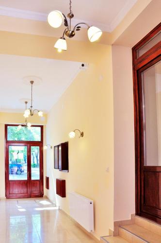 a hallway with a red door and a window at Partium Hotel Szeged in Szeged
