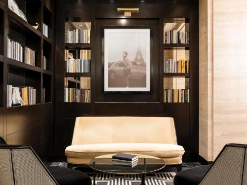 Una biblioteca con una silla y una foto de un hombre. en Sofitel Lafayette Square Washington DC, en Washington