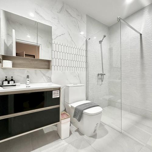 a bathroom with a toilet and a sink and a shower at J STAR in Jomtien Beach
